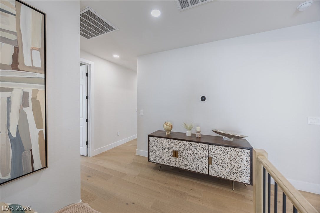 Corridor featuring light wood-style flooring and recessed lighting