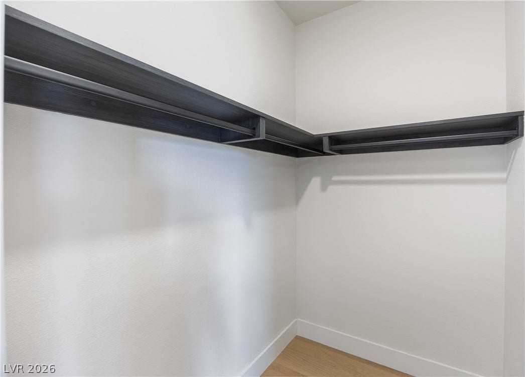 Walk in closet featuring light wood finished floors