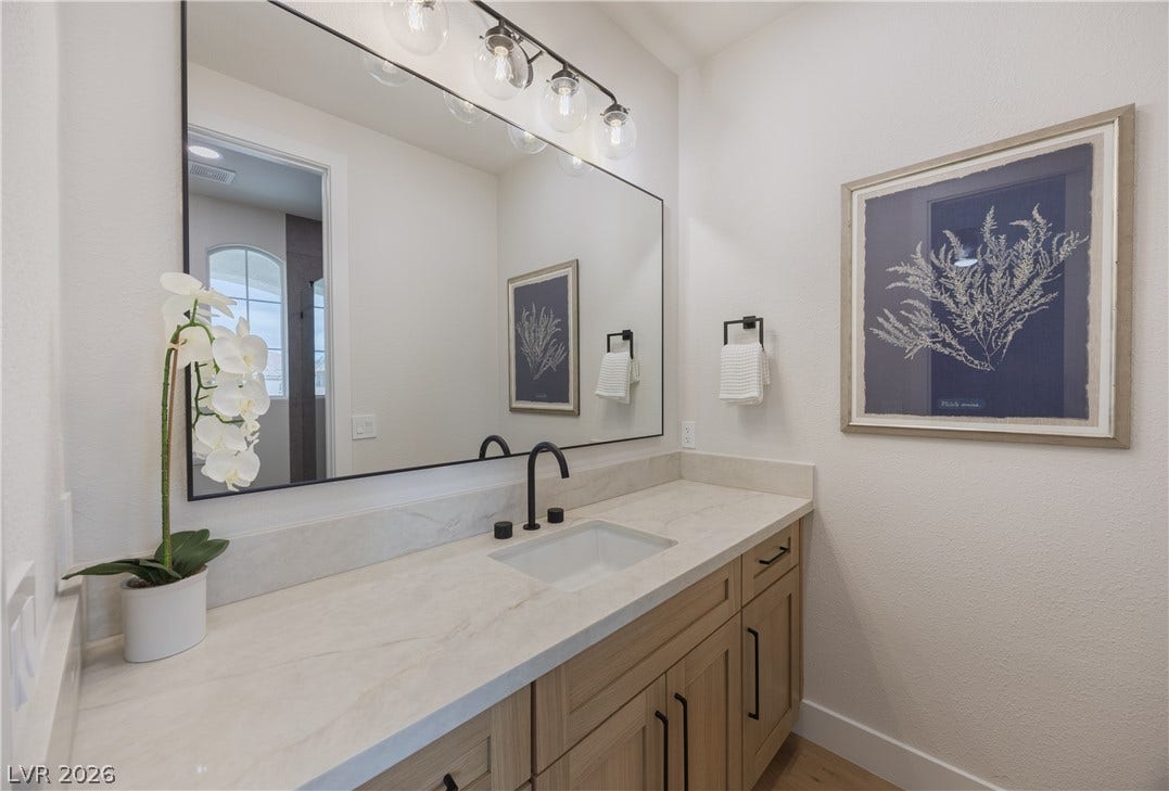 Bathroom with vanity and baseboards