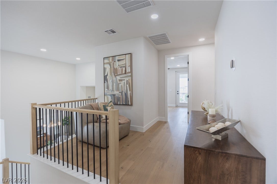 Hall featuring an upstairs landing, light wood-style floors, and recessed lighting