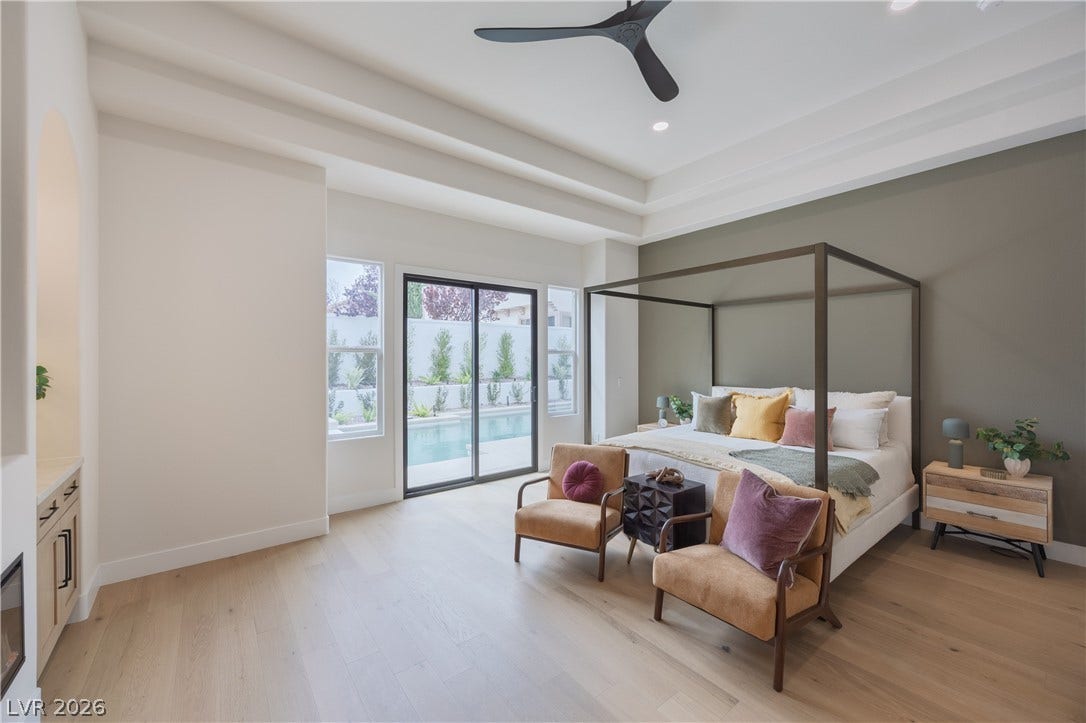 Bedroom with access to exterior, a tray ceiling, light wood-style flooring, a ceiling fan, and recessed lighting