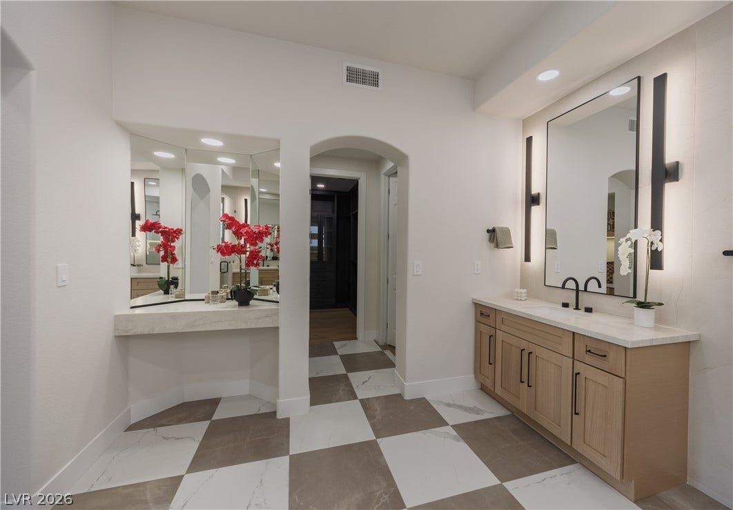 Bathroom featuring two vanities and recessed lighting