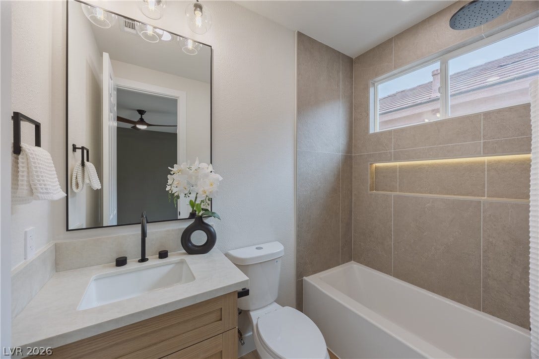 Full bathroom featuring vanity and a combined bath / shower with rainfall shower