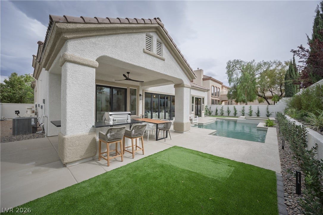 Back of property with exterior kitchen, a patio, ceiling fan, a fenced backyard, and stucco siding
