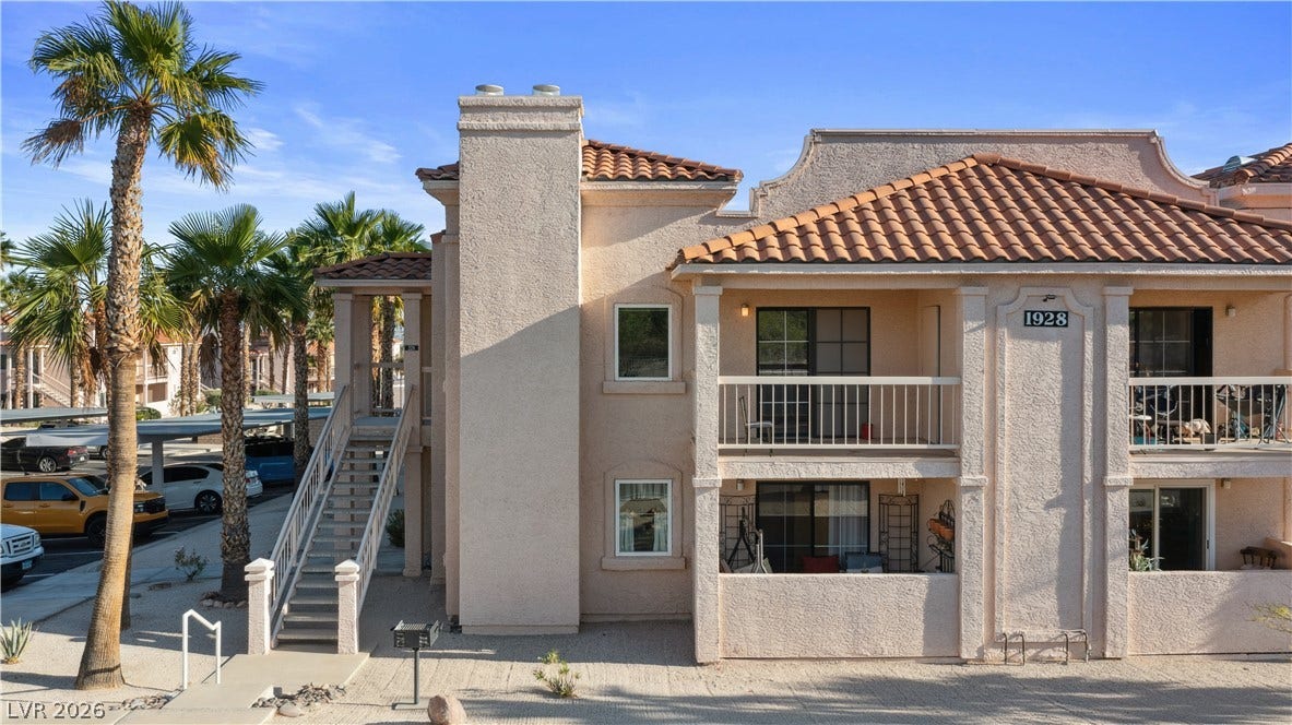 View of property with stairs