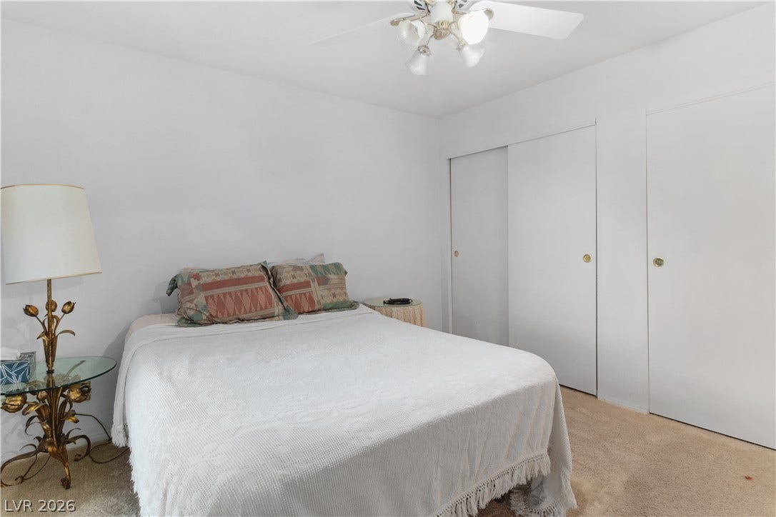 Primary Bedroom with light colored carpet, a closet, and ceiling fan