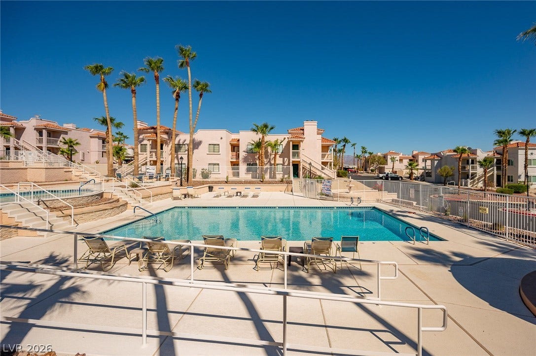 Community pool with a residential view and a patio