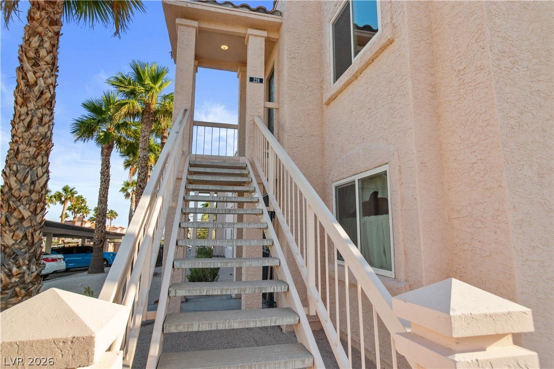 View of stairway to front door entry