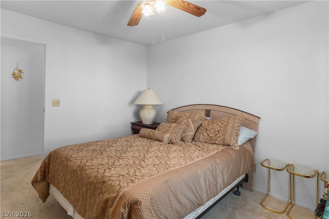 Carpeted Secondary bedroom featuring ceiling fan