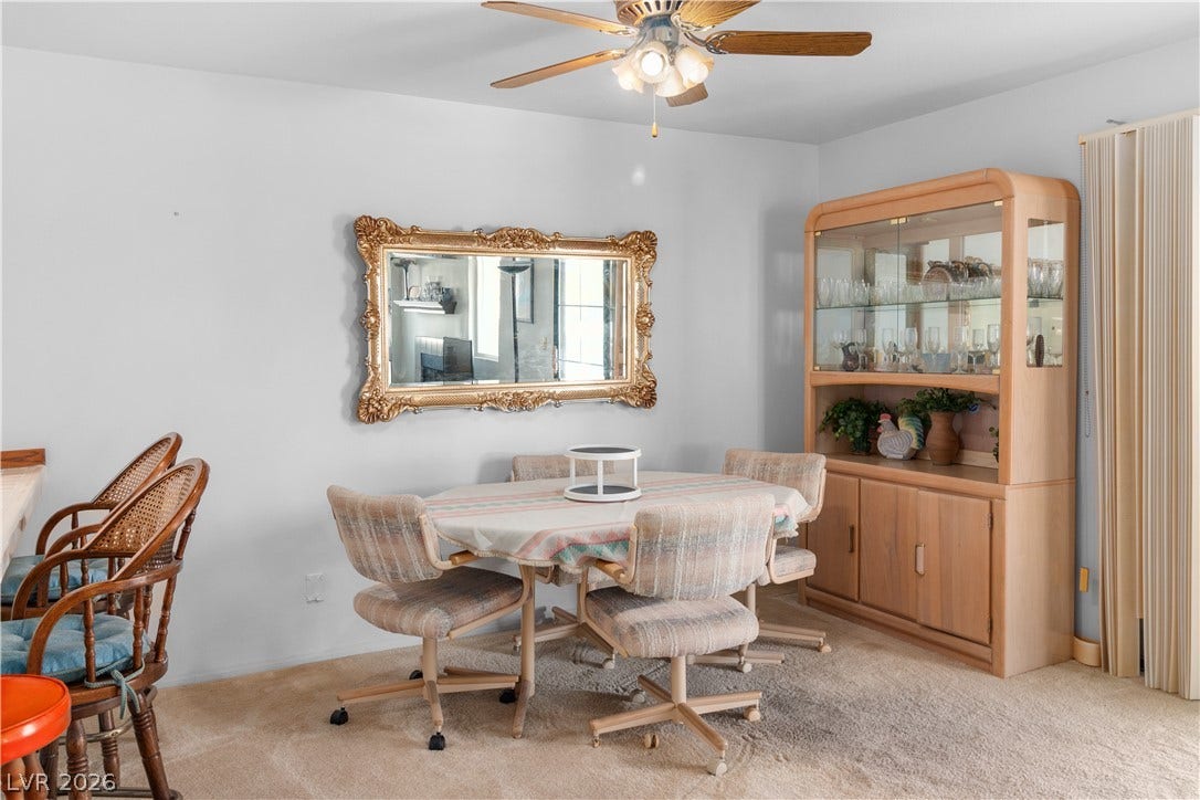 Dining room featuring light carpet and ceiling fan