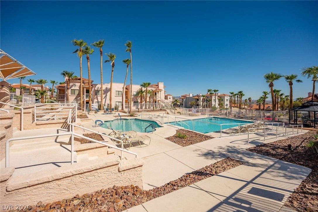 Community pool featuring a residential view and a patio area