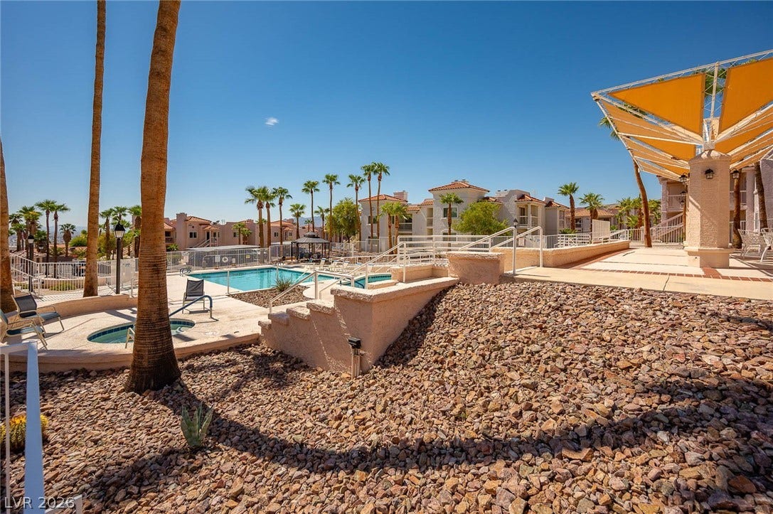 Community pool featuring a patio area and a residential view