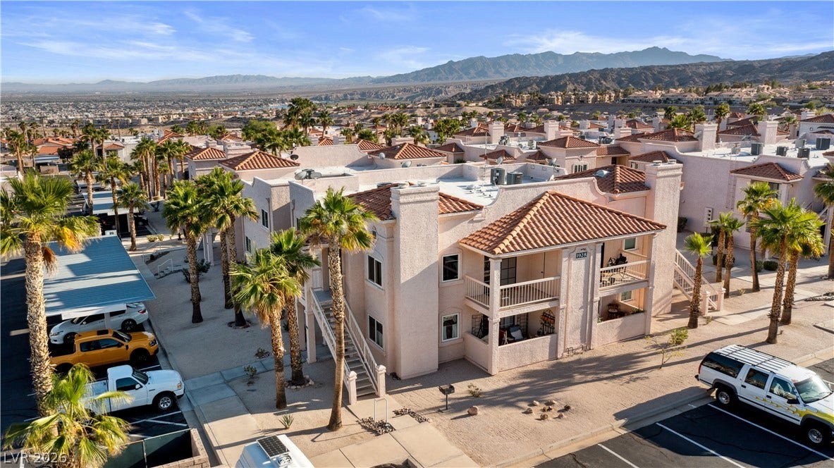 Aerial perspective of suburban area with a mountainous background