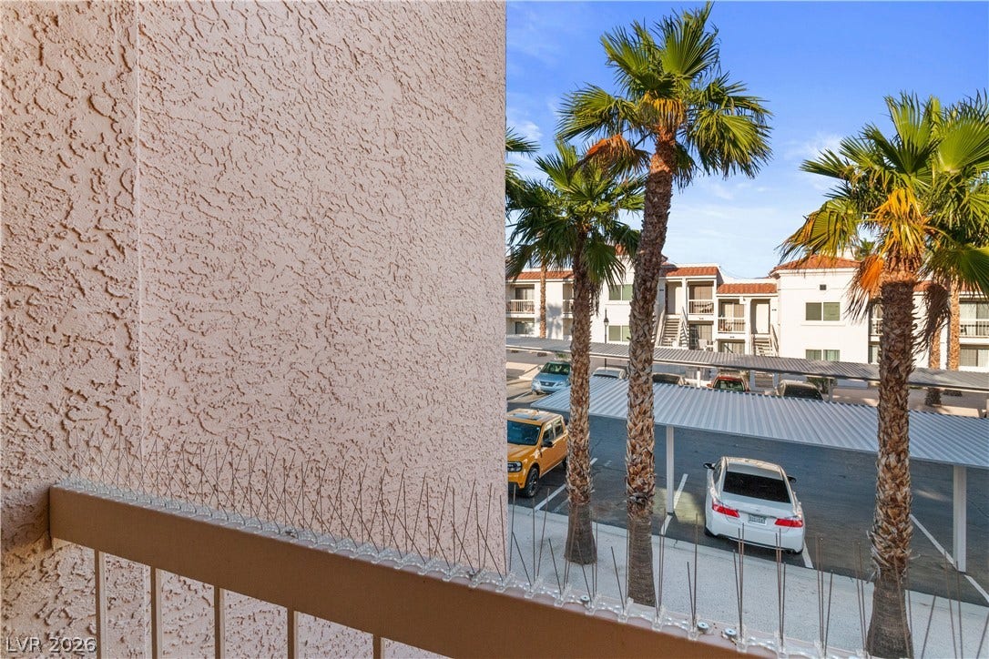 Exterior view of parking, stucco siding, and a residential view