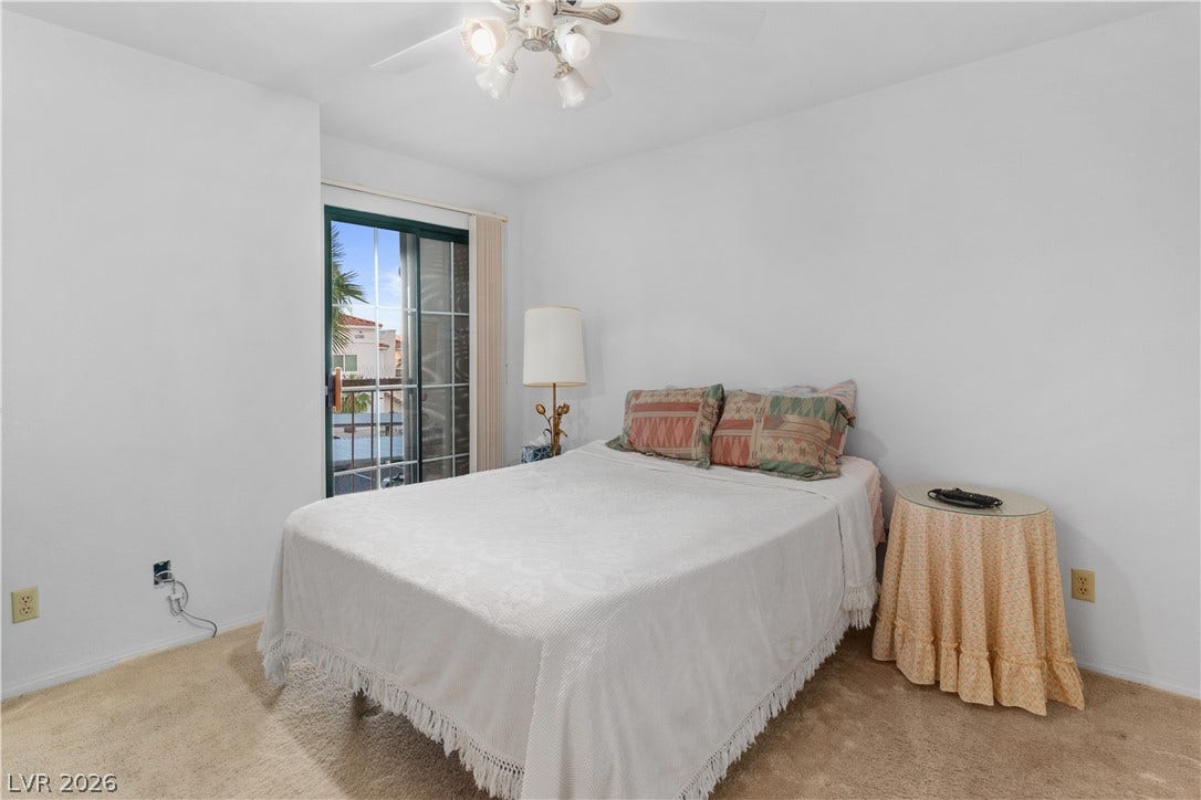 Carpeted Primary bedroom featuring baseboards and ceiling fan