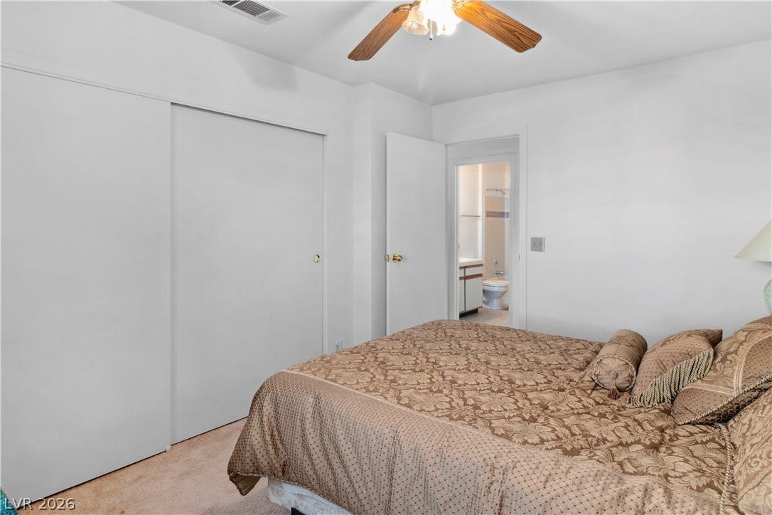 Secondary Bedroom with light colored carpet, a closet, and a ceiling fan