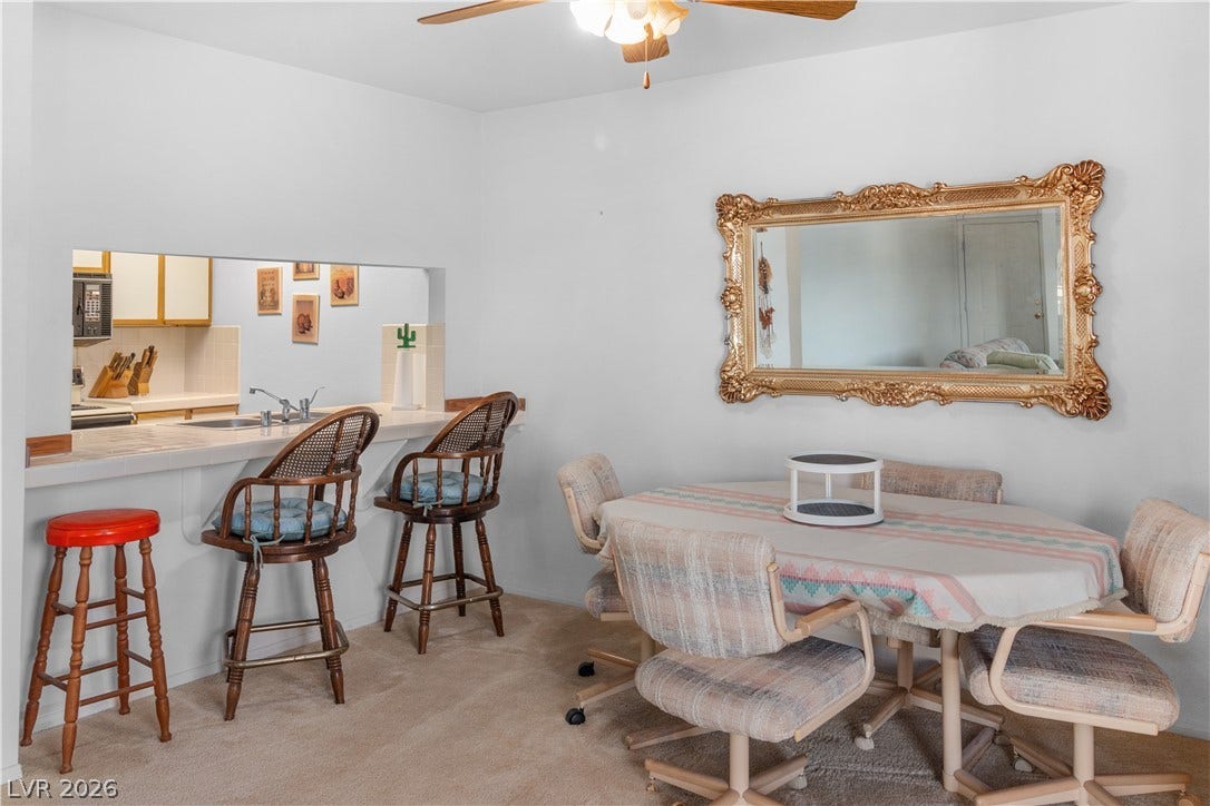 Dining area with ceiling fan and carpet flooring
