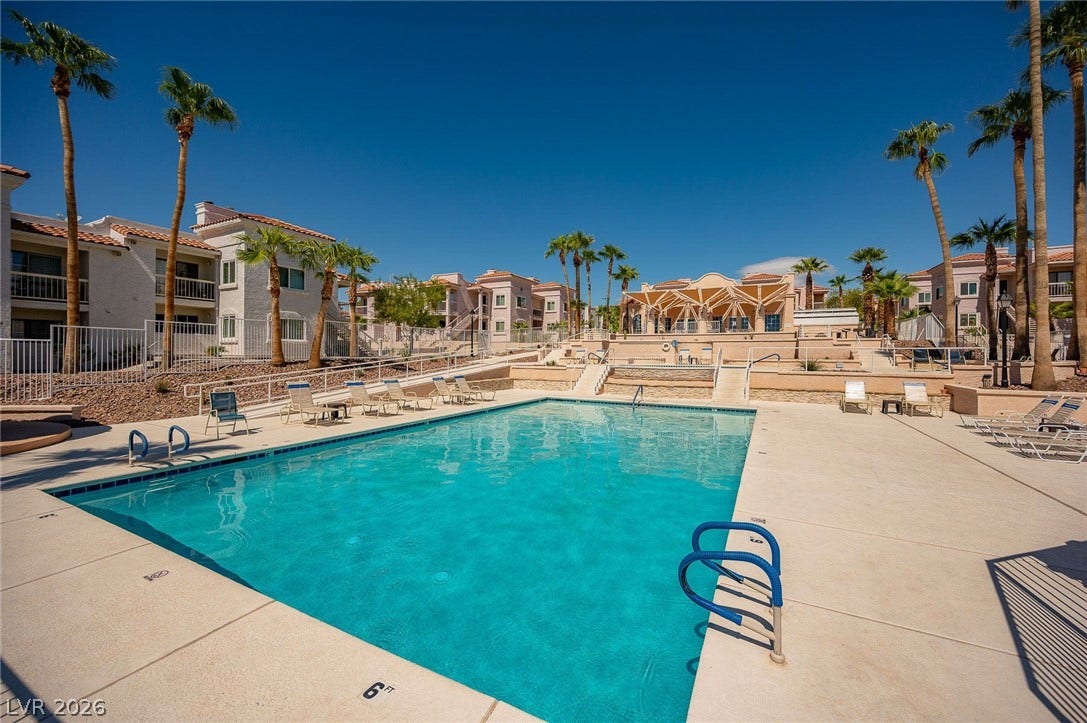 Community pool featuring a residential view and a patio