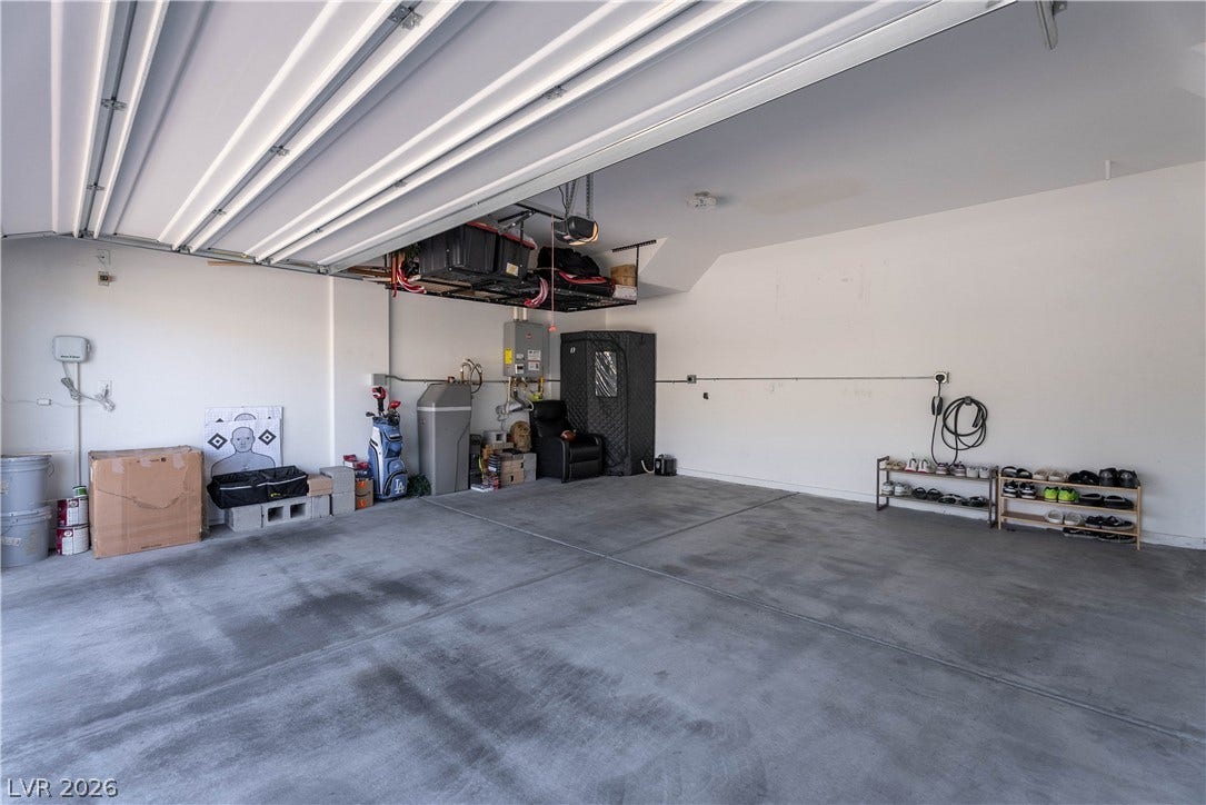 7061 Tilligerry Street, North Las Vegas, NV 89084 A spacious garage showcases durable concrete flooring and high ceilings.