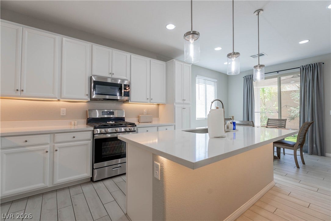 7061 Tilligerry Street, North Las Vegas, NV 89084 Gleaming quartz countertops and matching cabinetry anchor this modern culinary space.