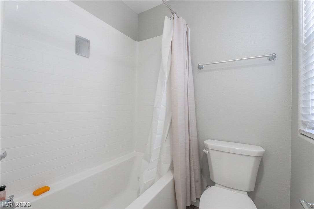 7061 Tilligerry Street, North Las Vegas, NV 89084 Clean lines and classic tile surround this tub and shower combination.