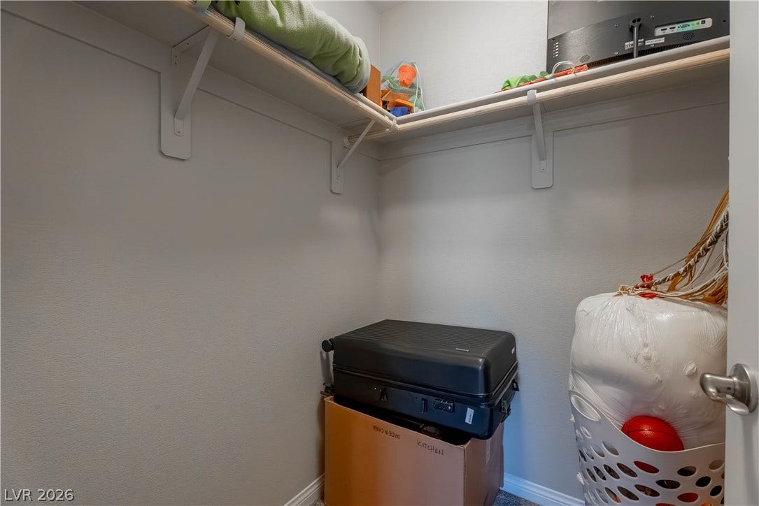 7061 Tilligerry Street, North Las Vegas, NV 89084 A functional walk-in closet provides built-in wooden shelving and ample storage space.