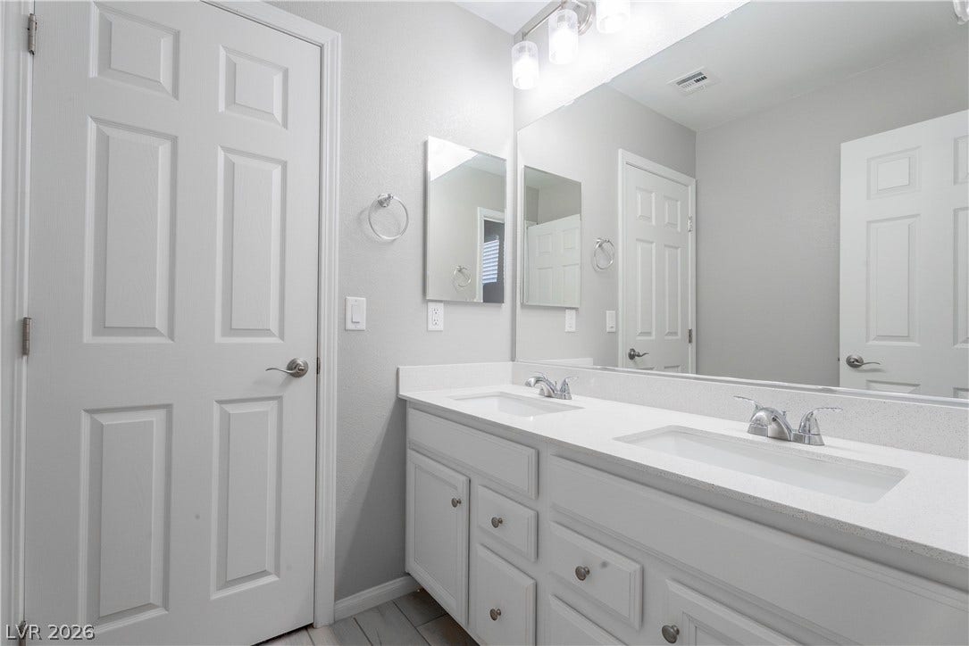 7061 Tilligerry Street, North Las Vegas, NV 89084 Clean lines and a spacious dual vanity define this functional bathroom space.