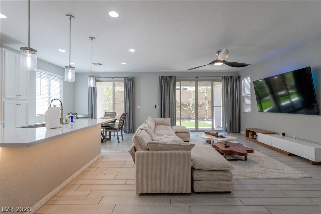 7061 Tilligerry Street, North Las Vegas, NV 89084 An open floorplan seamlessly connects the central living area to the kitchen and outdoors.