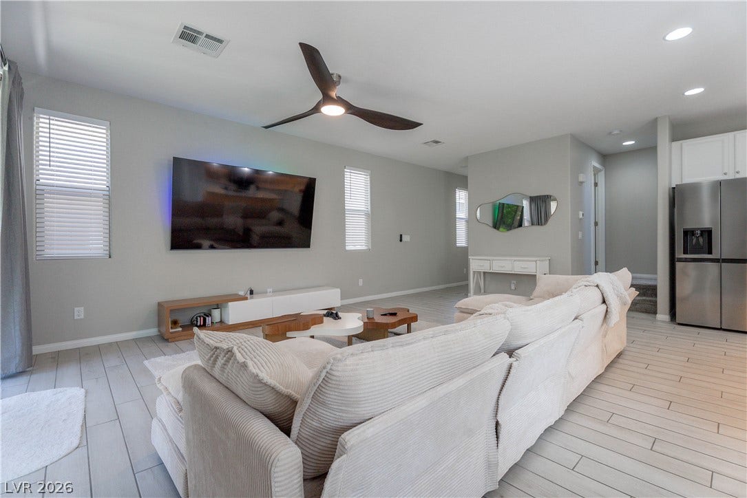 7061 Tilligerry Street, North Las Vegas, NV 89084 An open floor plan connects the comfortable living area to the kitchen.