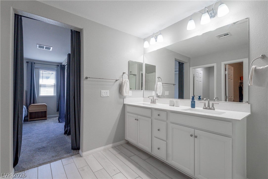 7061 Tilligerry Street, North Las Vegas, NV 89084 Clean lines and a spacious dual vanity define this bright bathroom space.