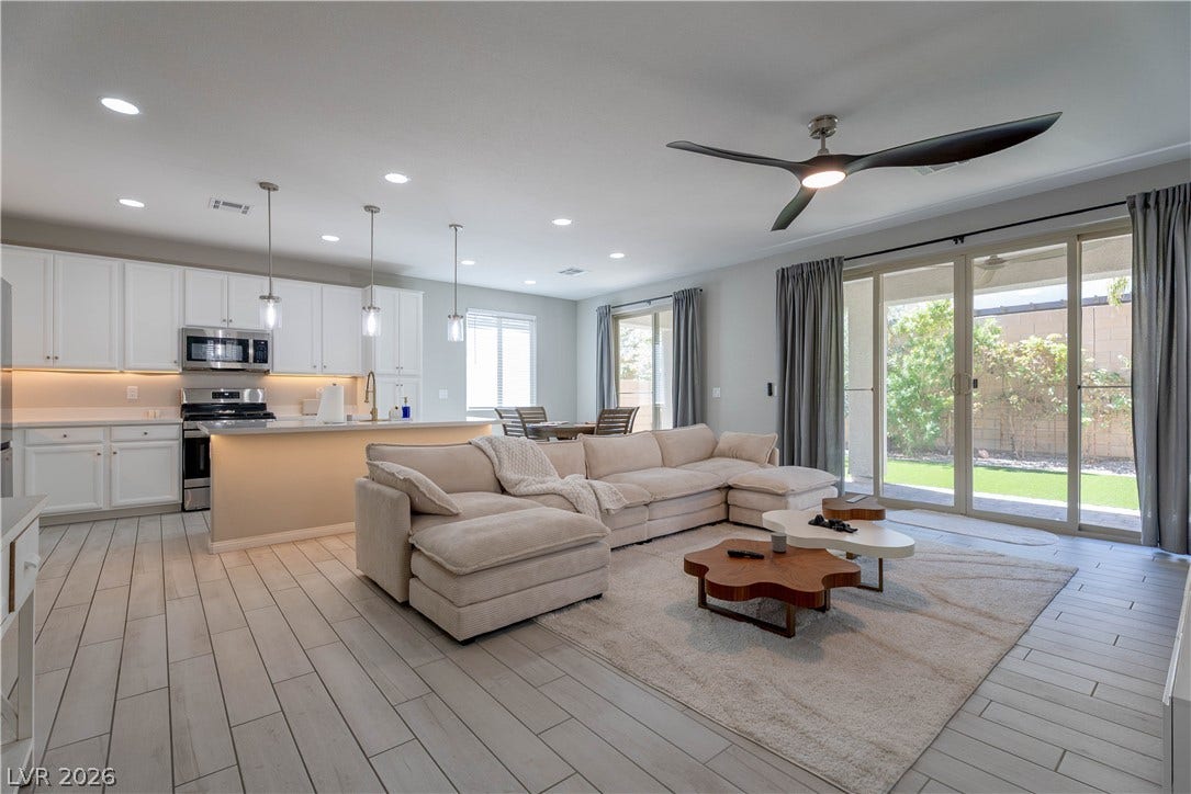 7061 Tilligerry Street, North Las Vegas, NV 89084 Sliding glass doors open to the backyard from this seamless main level living space.