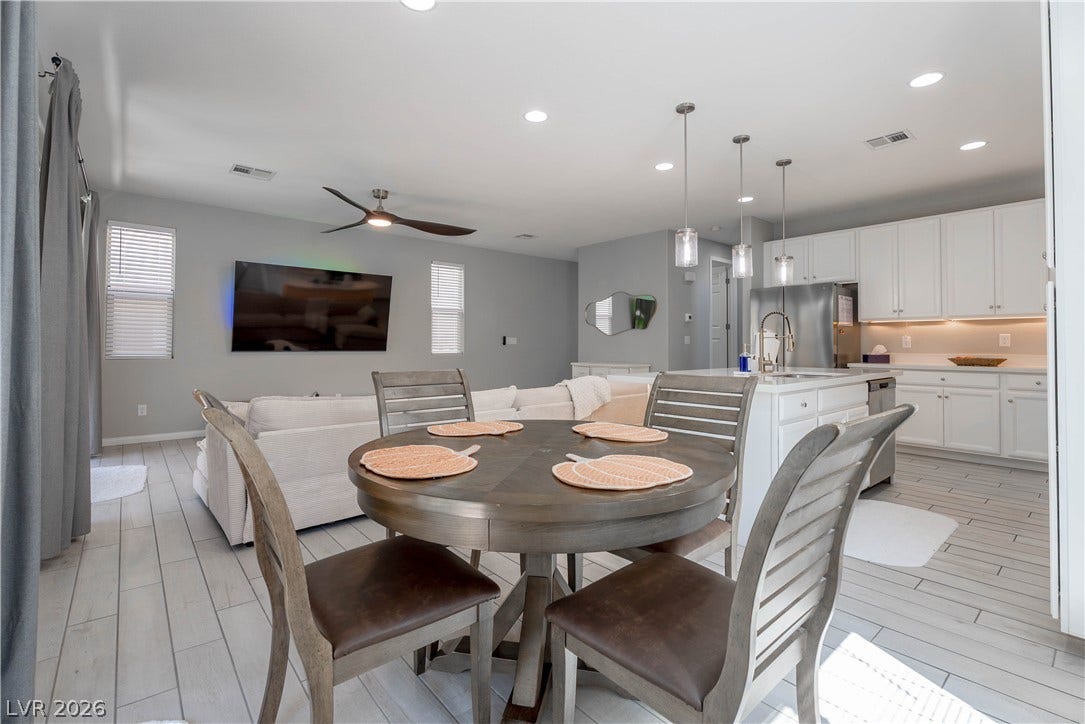 7061 Tilligerry Street, North Las Vegas, NV 89084 An open floor plan seamlessly connects the kitchen and dining areas over tiled flooring.