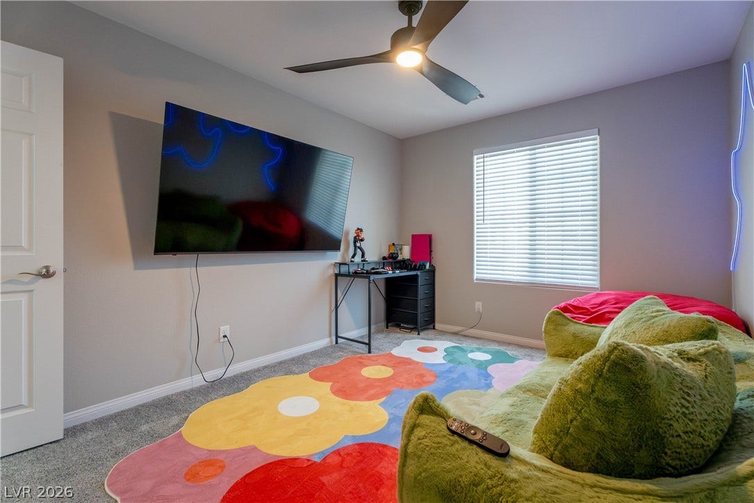 7061 Tilligerry Street, North Las Vegas, NV 89084 Plush wall-to-wall carpeting and a wide window define this comfortable space.