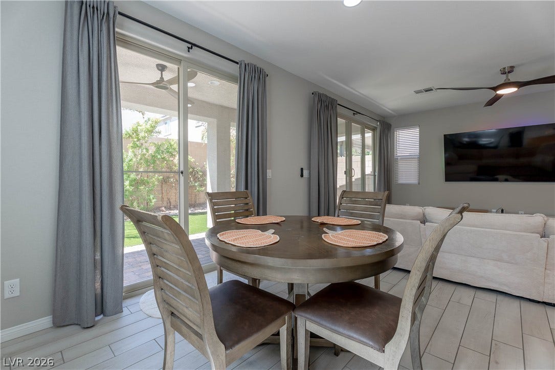 7061 Tilligerry Street, North Las Vegas, NV 89084 Sliding glass doors open directly to the outdoor patio from the dining area.