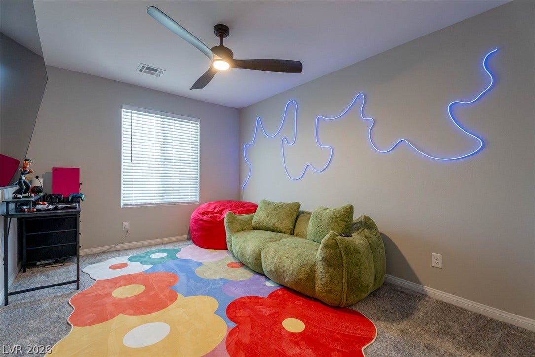 7061 Tilligerry Street, North Las Vegas, NV 89084 Soft carpeting underfoot and a large window create a comfortable, well-lit secondary space.