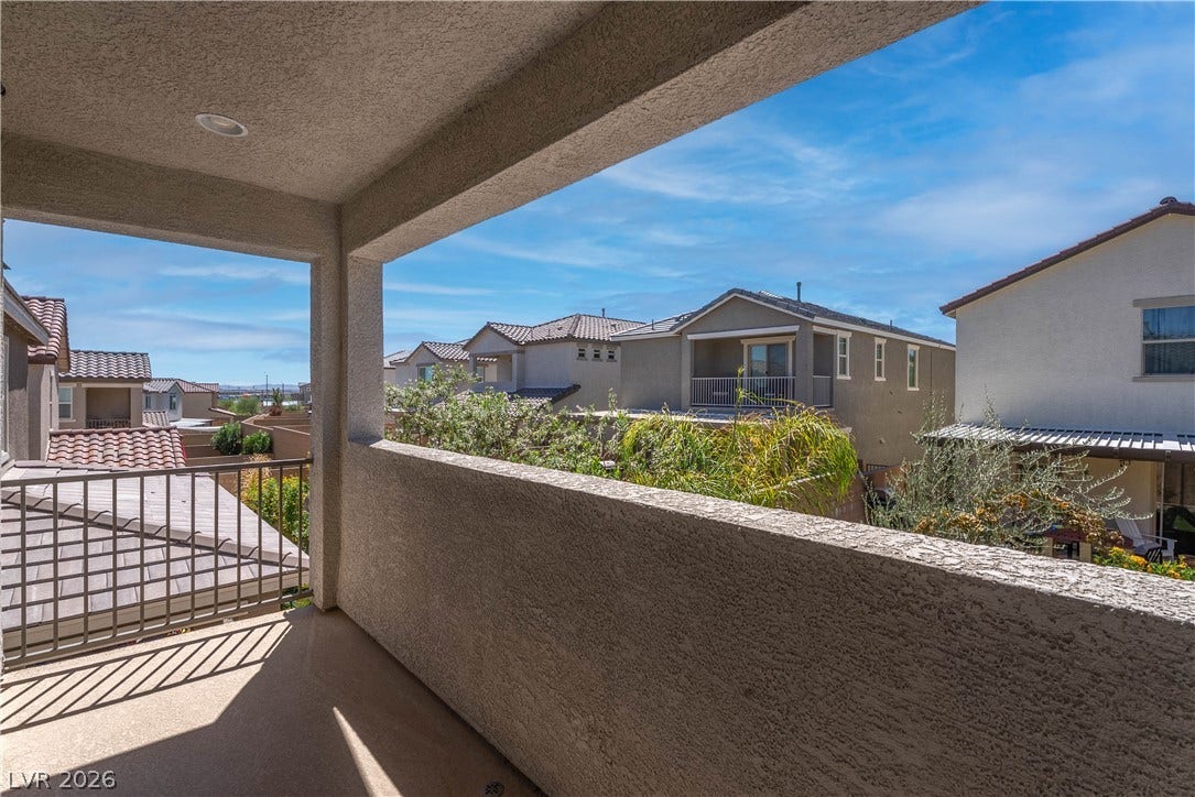 7061 Tilligerry Street, North Las Vegas, NV 89084 A stucco balcony provides a sheltered outdoor space overlooking the surrounding neighborhood.
