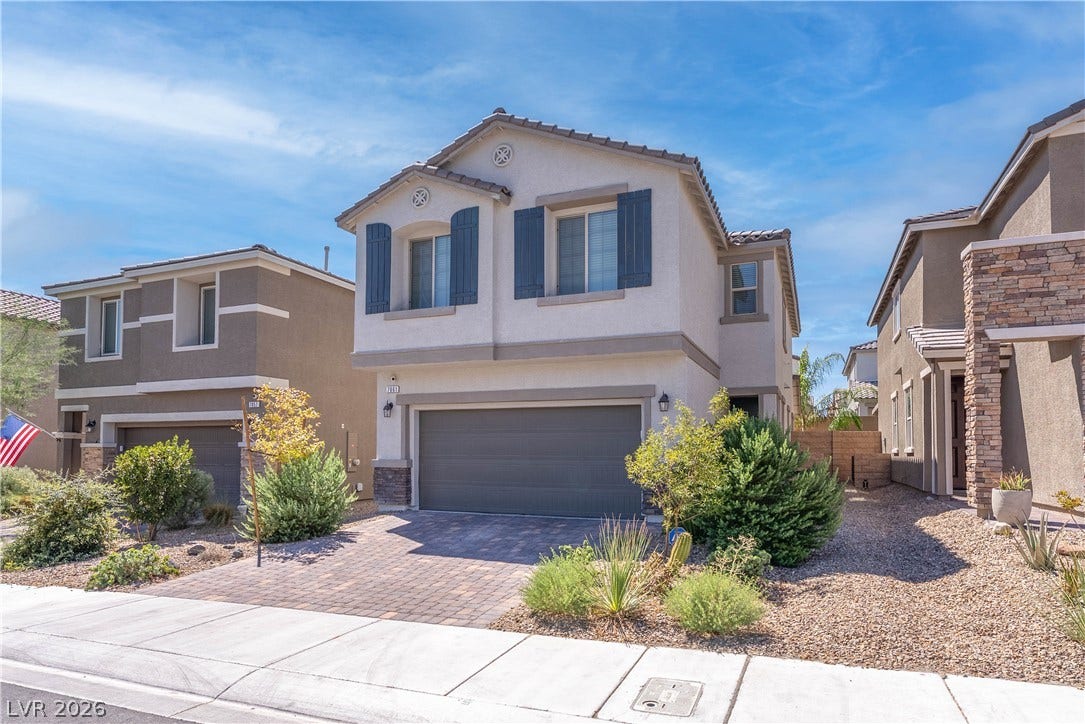 7061 Tilligerry Street, North Las Vegas, NV 89084 Desert landscaping and a paved driveway complement this two-story exterior.