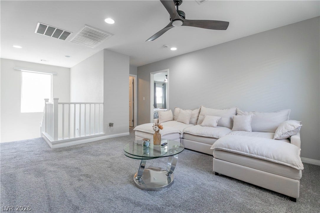 7061 Tilligerry Street, North Las Vegas, NV 89084 Plush carpeting anchors this versatile upstairs loft space highlighted by clean architectural lines.