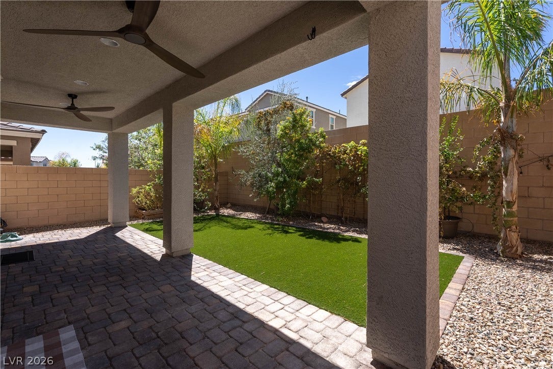 7061 Tilligerry Street, North Las Vegas, NV 89084 A covered paver patio looks out over a private, low-maintenance backyard enclosed by block fencing.