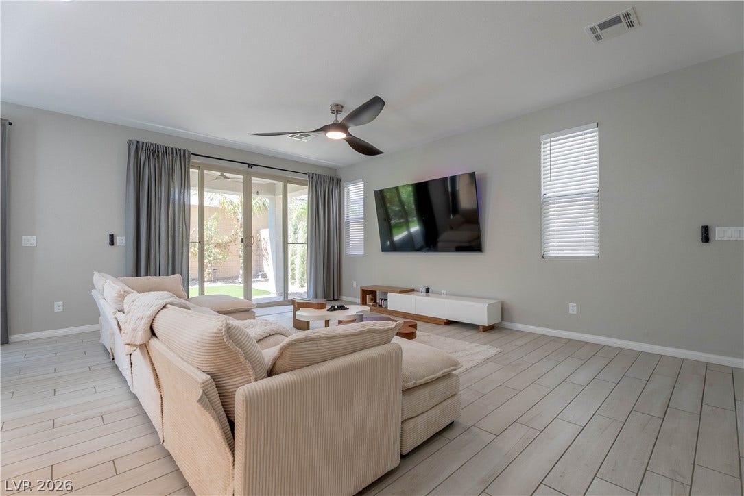 7061 Tilligerry Street, North Las Vegas, NV 89084 Sliding glass doors open directly to the outdoor patio from this tiled living space.