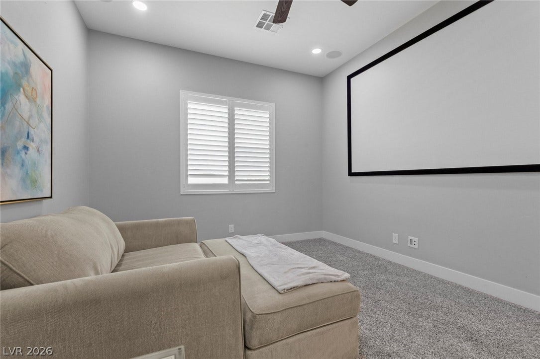 9841 W El Campo Grande Avenue, Las Vegas, NV 89149 An inviting media room for movie nights features soft carpet and a large projection screen.