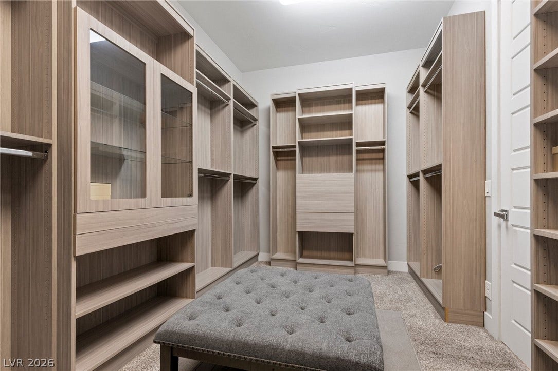 9841 W El Campo Grande Avenue, Las Vegas, NV 89149 Customizable closet shelving provides versatile storage solutions in this spacious walk-in.