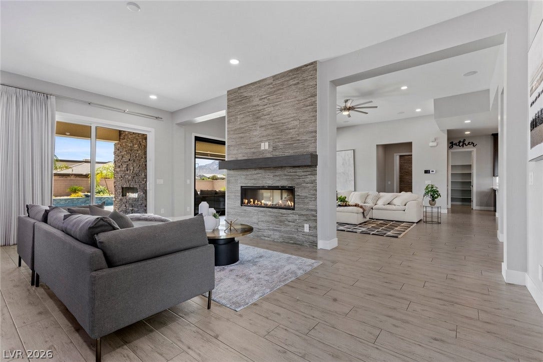 9841 W El Campo Grande Avenue, Las Vegas, NV 89149 A striking fireplace feature wall anchors this modern great room with ample space for relaxation and entertainment.