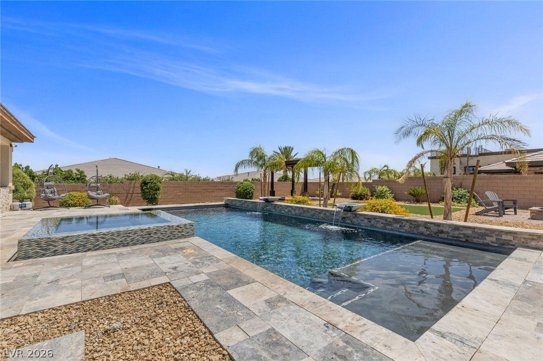 9841 W El Campo Grande Avenue, Las Vegas, NV 89149 An inviting backyard oasis offers a sparkling pool and rejuvenating spa, perfect for outdoor leisure.