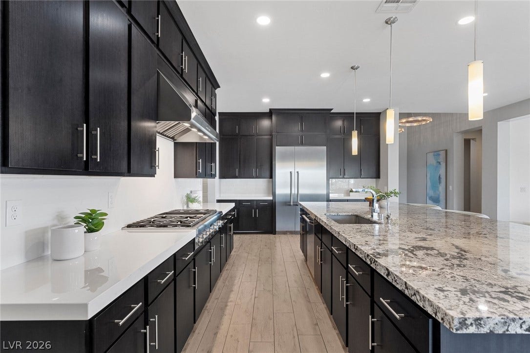 9841 W El Campo Grande Avenue, Las Vegas, NV 89149 Culinary aspirations meet sophisticated design in this beautifully appointed kitchen, featuring abundant storage and seamless entertaining space.