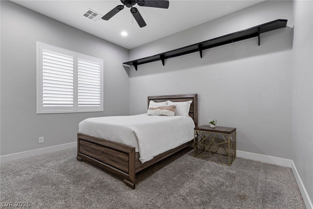 9841 W El Campo Grande Avenue, Las Vegas, NV 89149 Well-lit sleeping quarters with elegant window shutters and ample floor space.