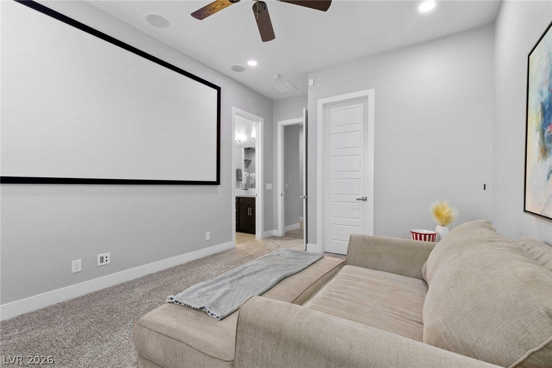9841 W El Campo Grande Avenue, Las Vegas, NV 89149 Experience movie nights in this dedicated media room with a projector screen and plush seating.