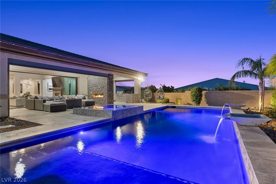 9841 W El Campo Grande Avenue, Las Vegas, NV 89149 A dazzling blue-lit pool and spa complement an inviting outdoor living area with a fireplace and built-in barbecue.