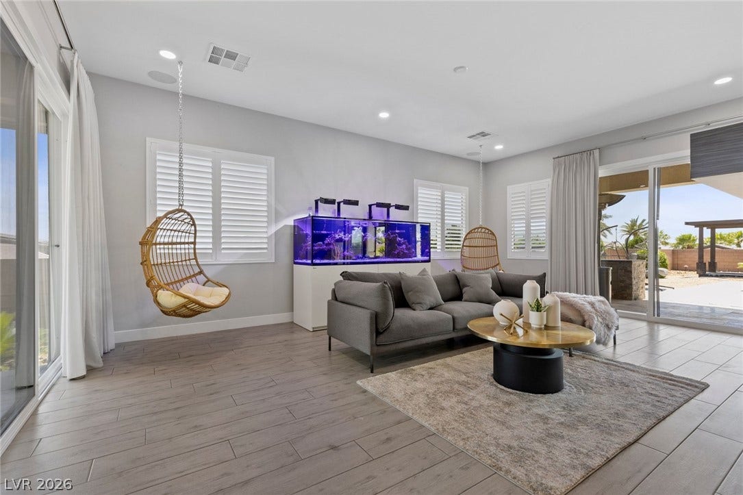 9841 W El Campo Grande Avenue, Las Vegas, NV 89149 Sliding glass doors open to an outdoor area, enhancing this generously proportioned gathering space.