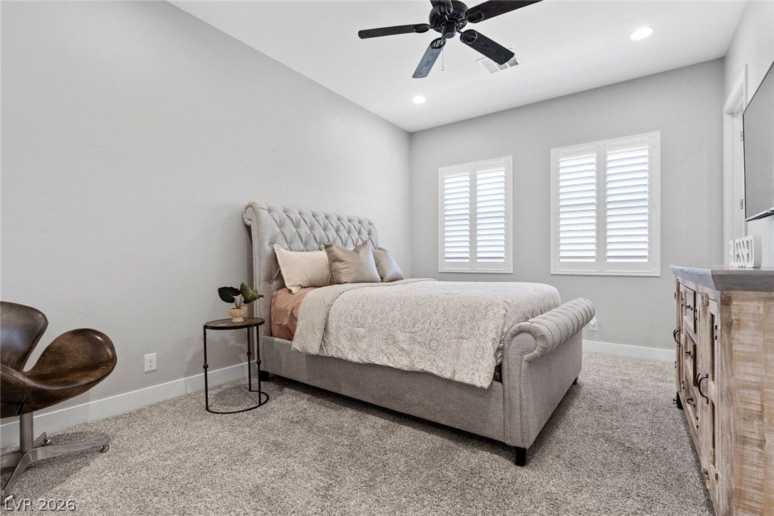 9841 W El Campo Grande Avenue, Las Vegas, NV 89149 Plush carpeting and crisp white shutters create a serene retreat in this comfortable sleeping area.